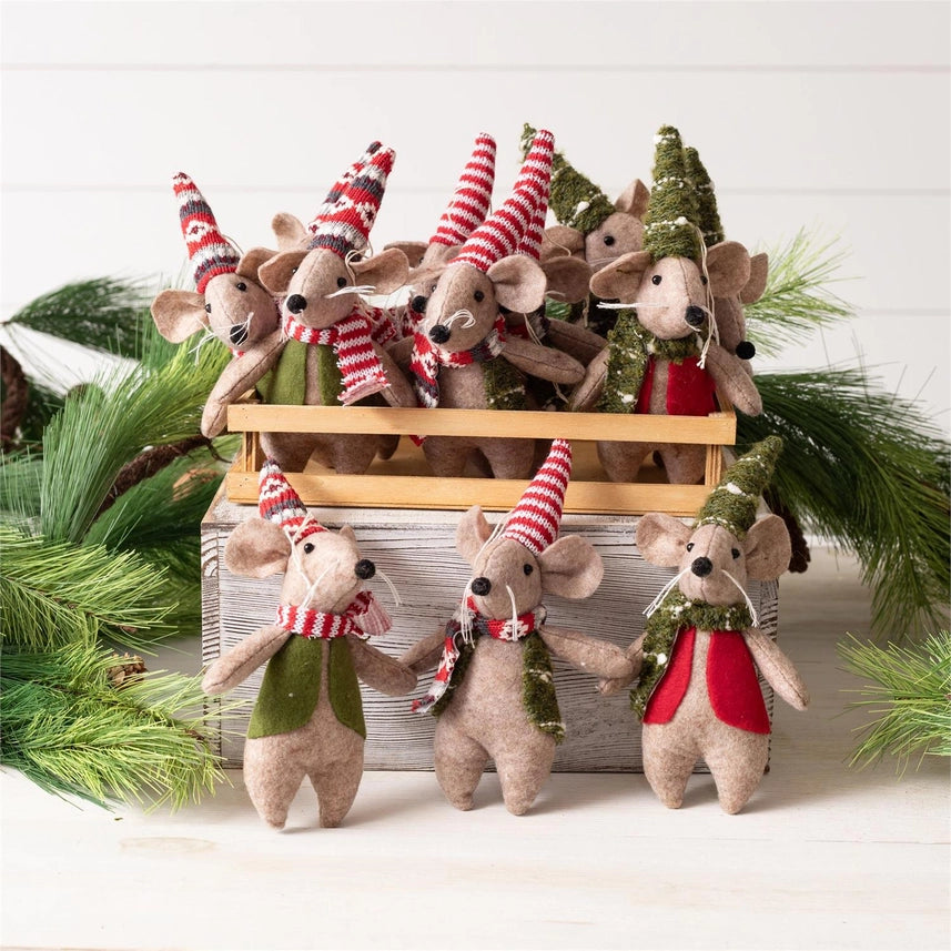 A milk crate full of assorted felt mice with varying vests, scarves, and hats that are green, red, and white with varying patterns.