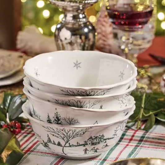 Stack of decorative toile bowls on a festive table with Christmas decorations in the background