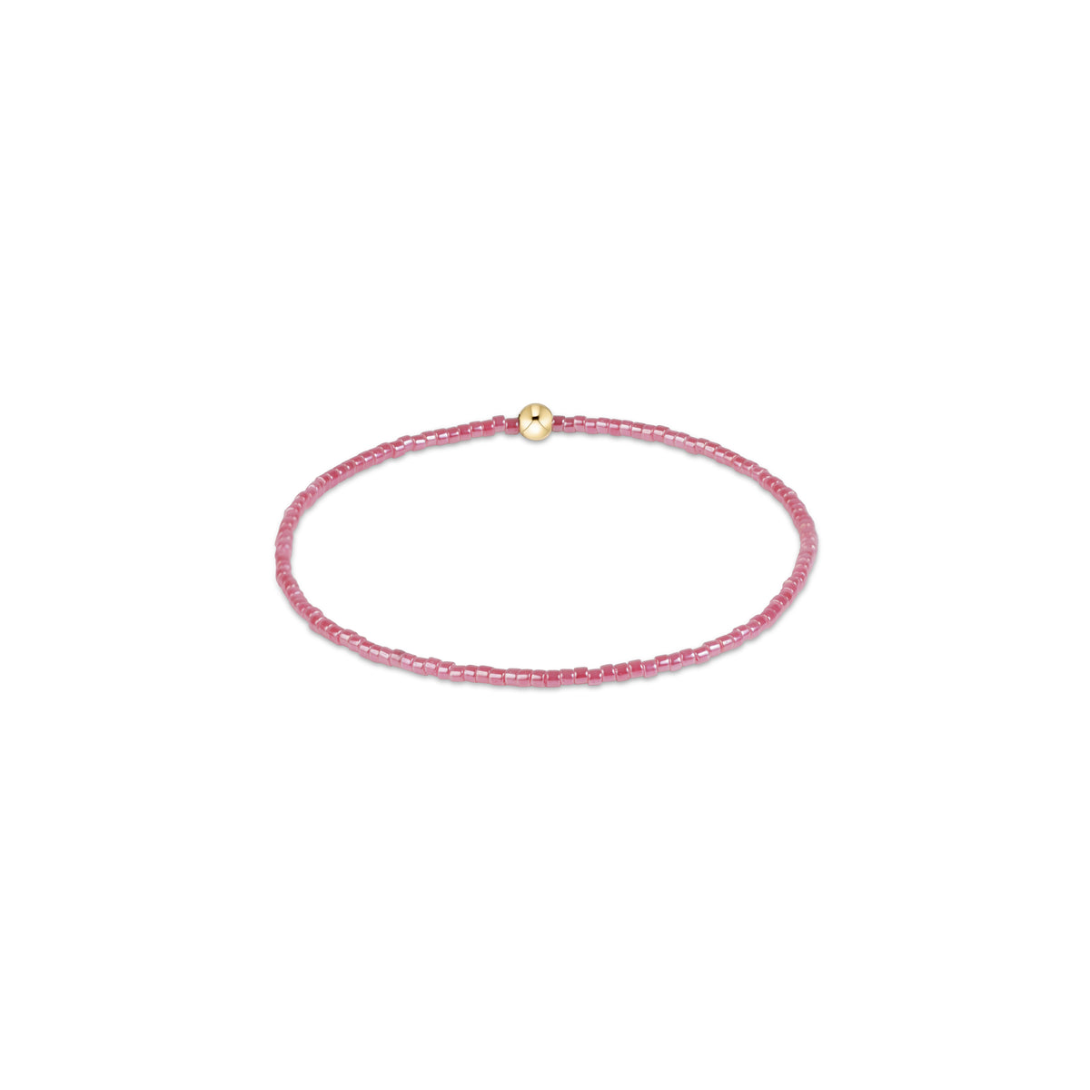 A delicate pink beaded bracelet with a small gold-toned round bead accent, displayed on a clean white background.