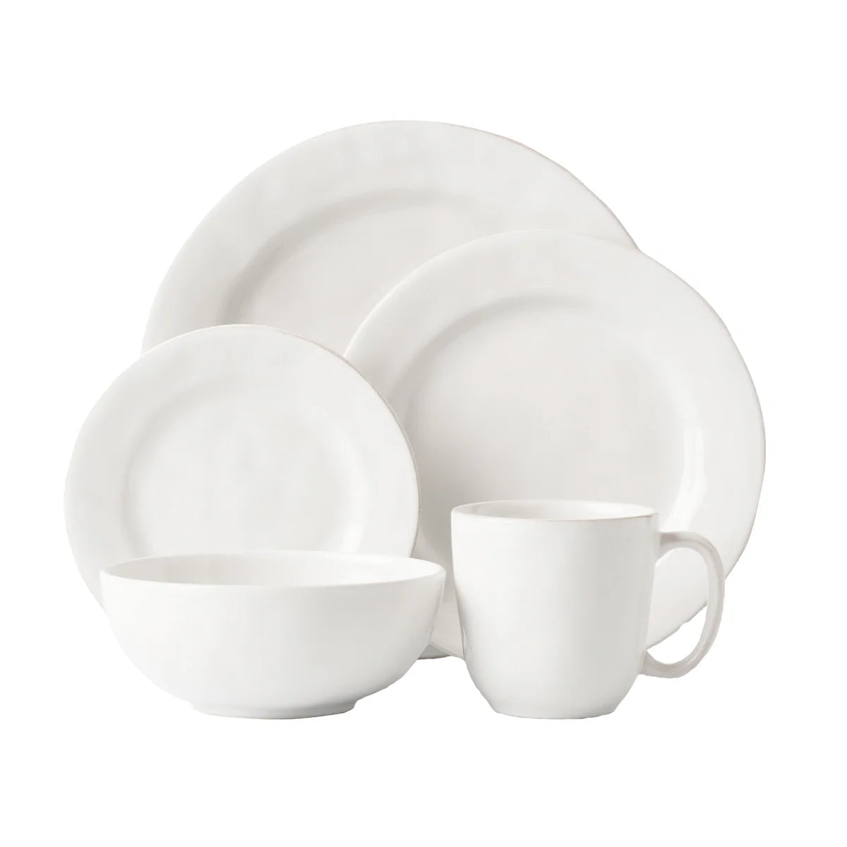White ceramic dinnerware set on a white background