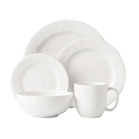 White ceramic dinnerware set on a white background