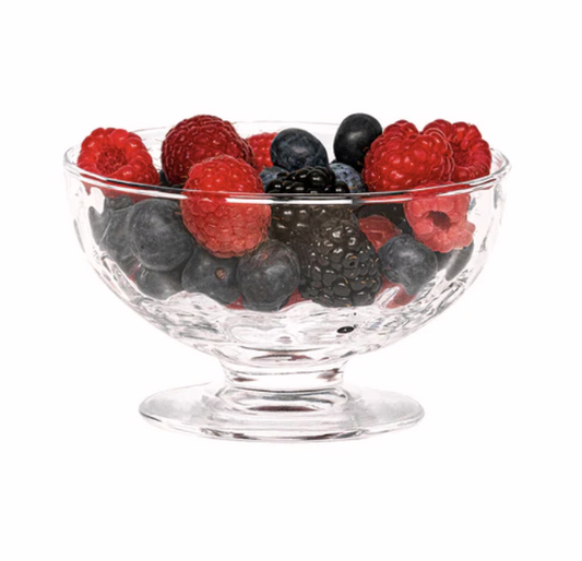 Clear glass bowl filled with mixed berries on a white background