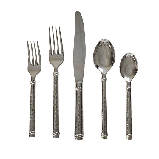 Set of silver cutlery with hammered textured handles on a white background