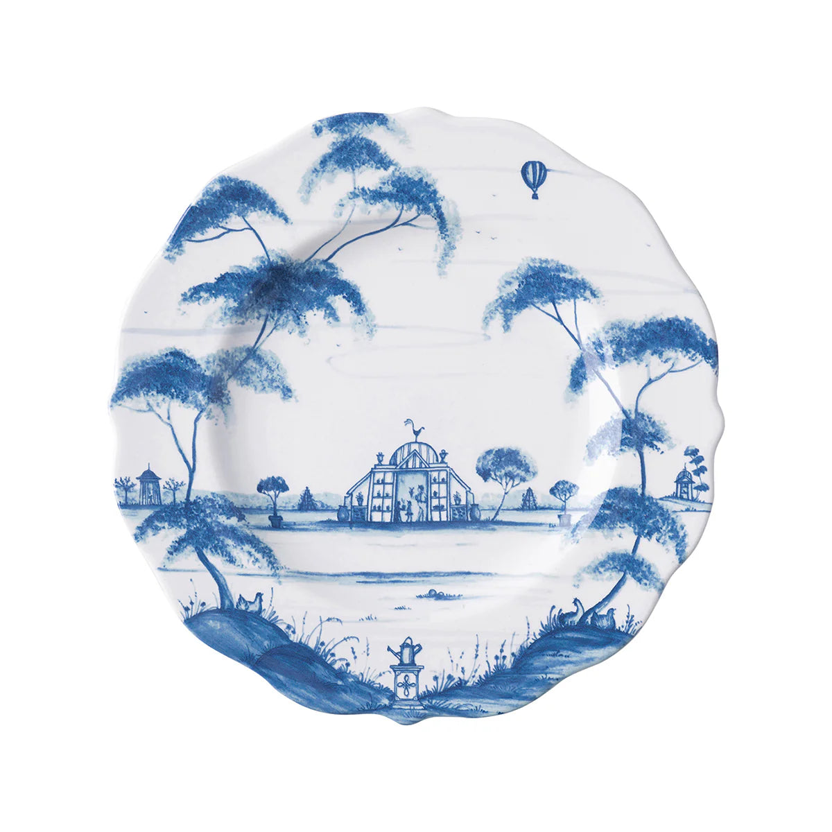 Decorative salad plate with blue toile landscape design on a white background