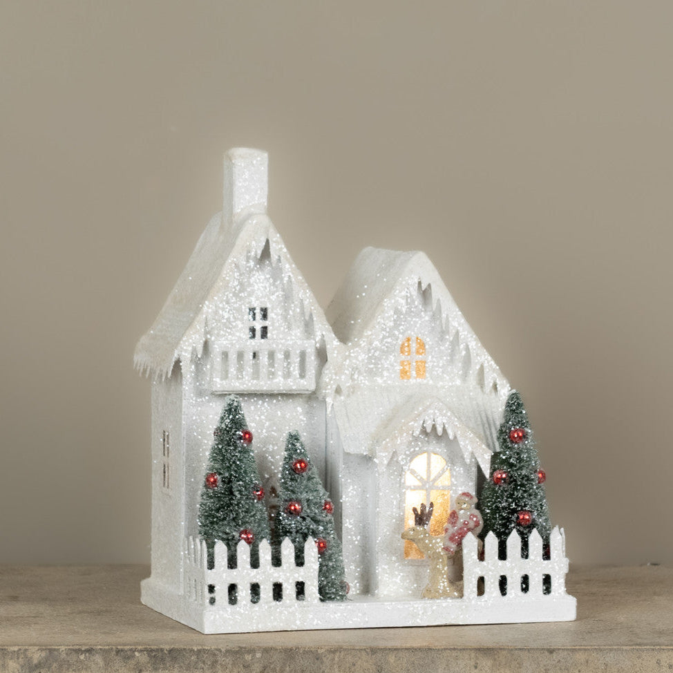 Lighted Snow Covered House with Balcony