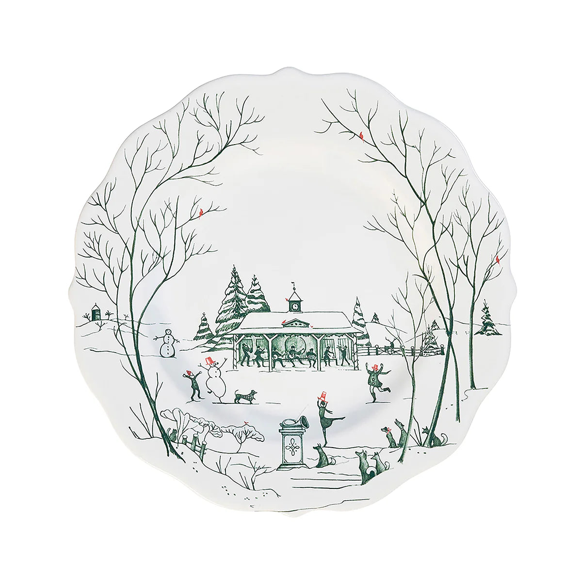 Decorative white plate with green toile winter scene design featuring trees, a stable, and people in a snowy landscape.