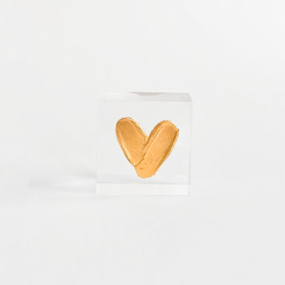 Gold heart-shaped object on a white background
