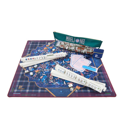 An active game of mahjong featuring a deep purple, blue, and gold mahjong mat.