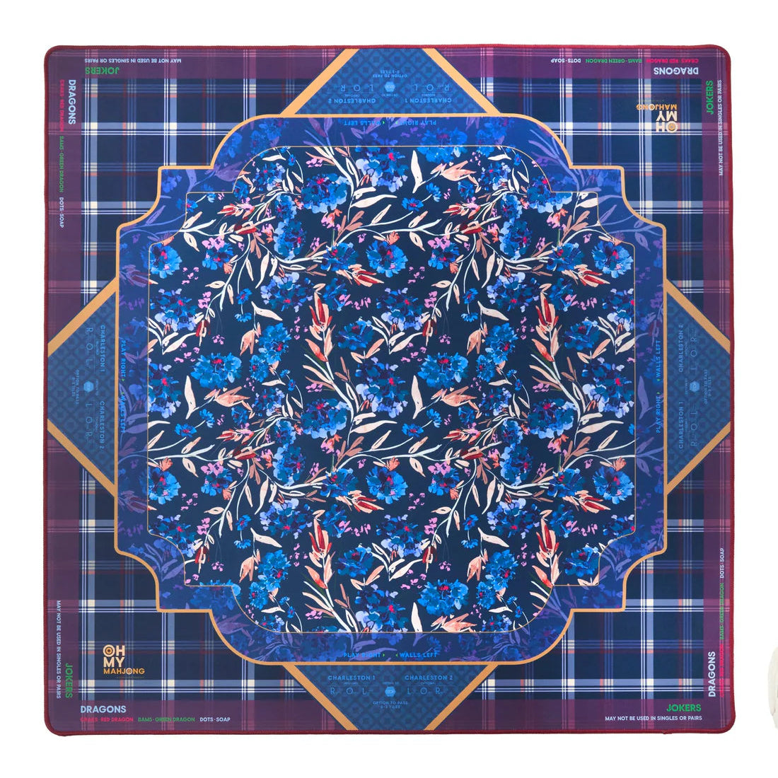 A mahjong mat with a plaid background and a floral focal pattern towards the center. Assorted colors of deep purples, blues, and golds.