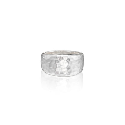 A hammered silver band ring with a textured, dimpled surface, shown on a clean white background with a soft reflection below.