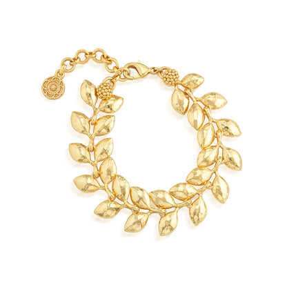 Gold bracelet with leaf-like design on a white background