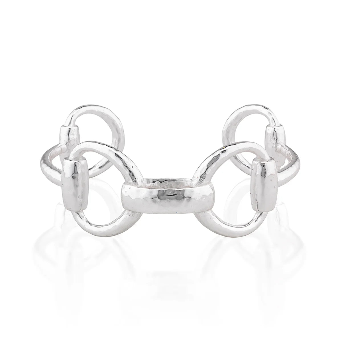 A polished silver horse bit cuff bracelet with a hammered finish and polished links, displayed on a clean white reflective surface.