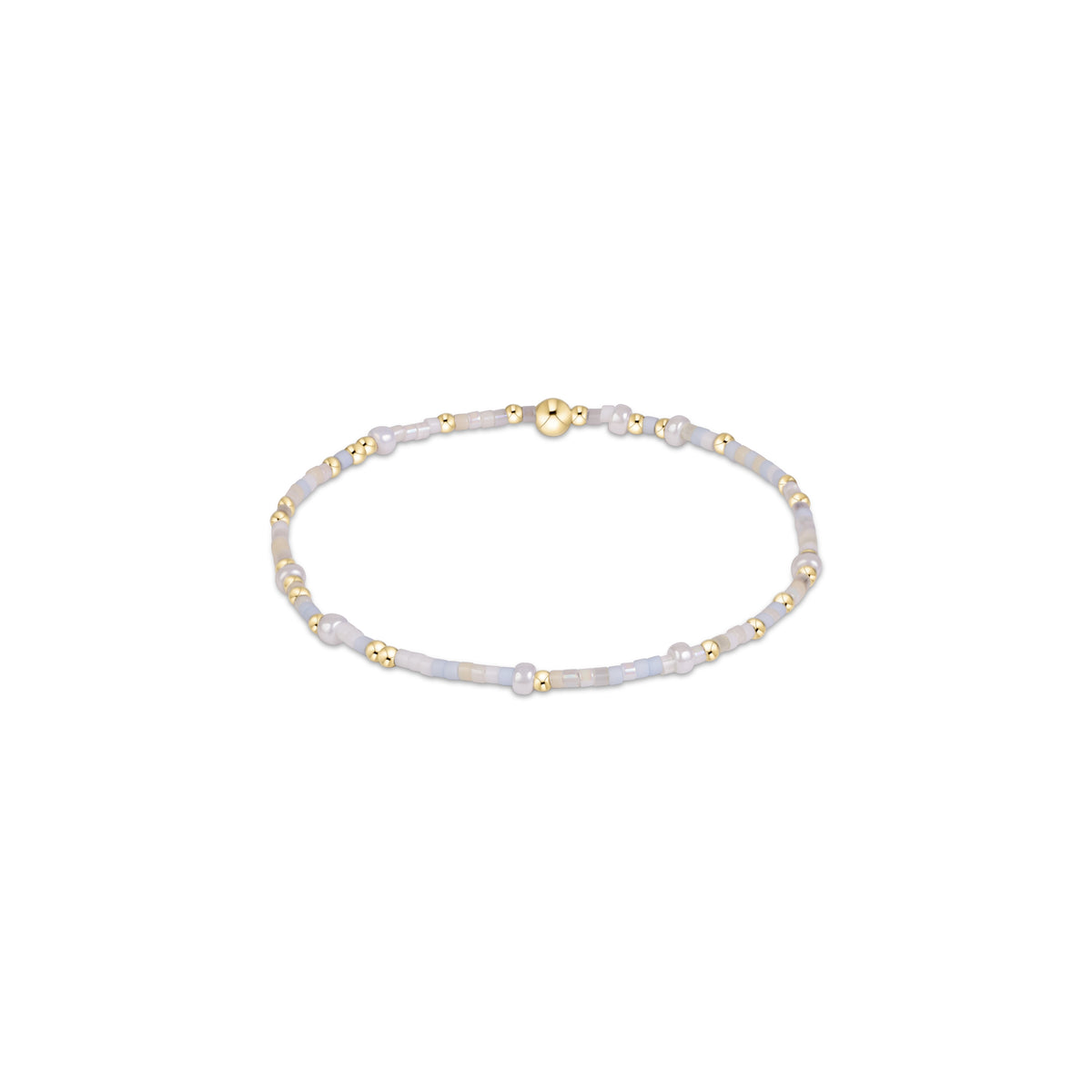 A delicate beaded bracelet featuring pale lavender-gray beads, small gold spacer beads, .