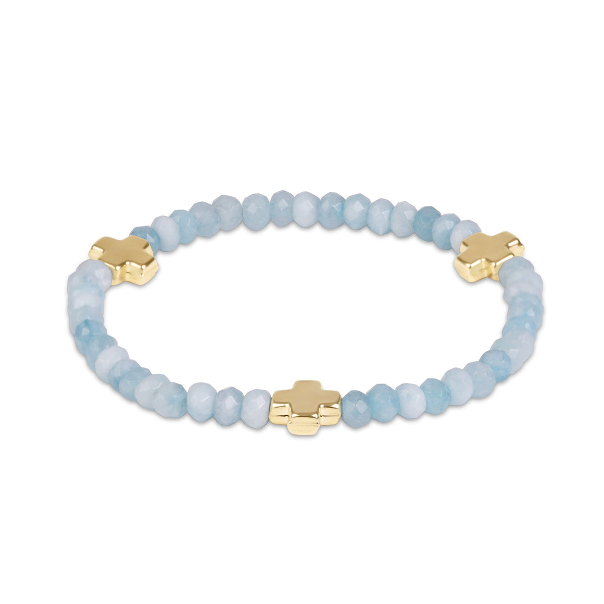 A beaded stretch bracelet featuring light blue faceted beads and three gold-plated cross charms.
