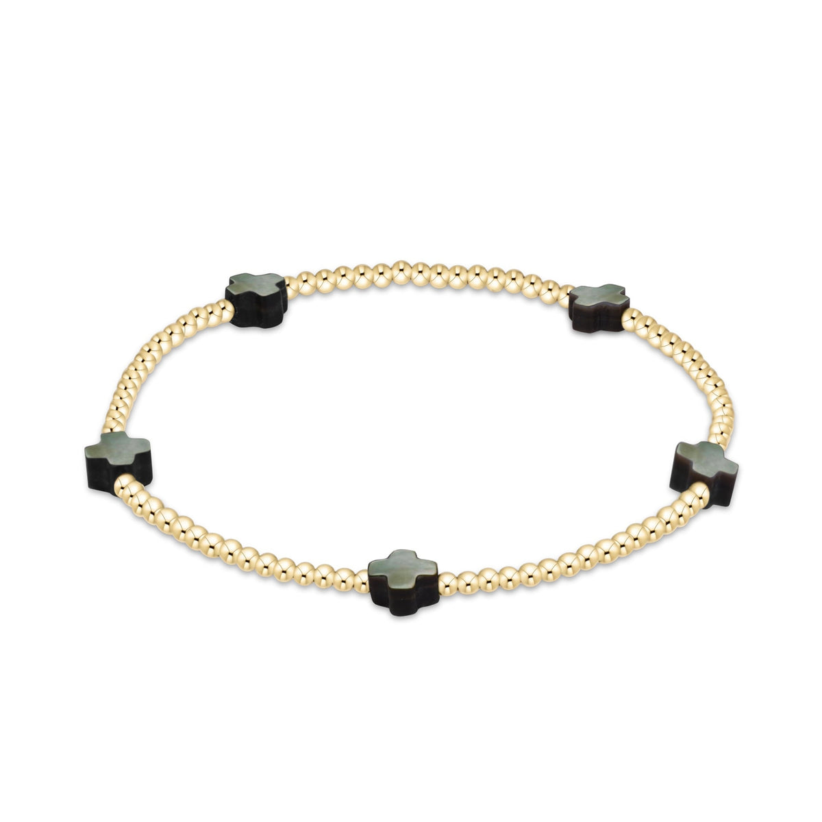 A gold beaded bracelet with five black clover-shaped charms, each featuring a light green center.