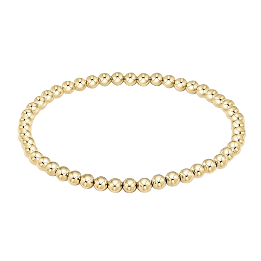 Gold beaded bracelet on a white background