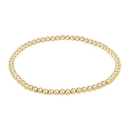 Gold beaded bracelet on a white background