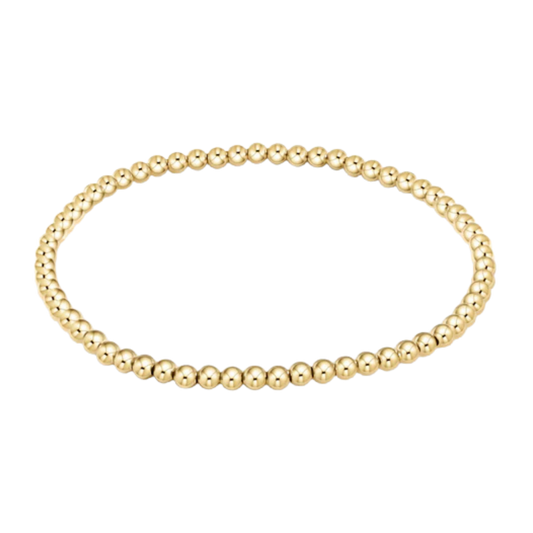 Gold beaded bracelet on a white background