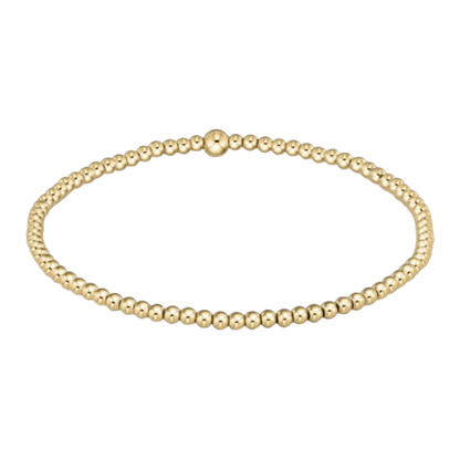 Gold beaded bracelet on a white background