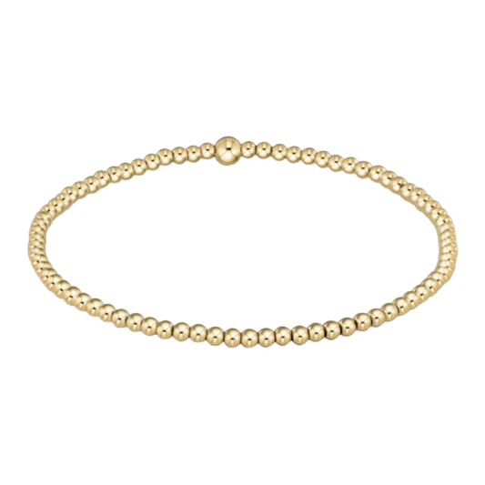 Gold beaded bracelet on a white background