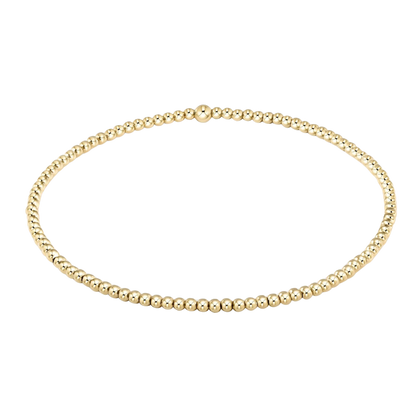 Gold beaded necklace on a white background