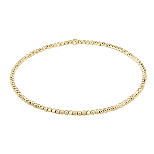 Gold beaded necklace on a white background