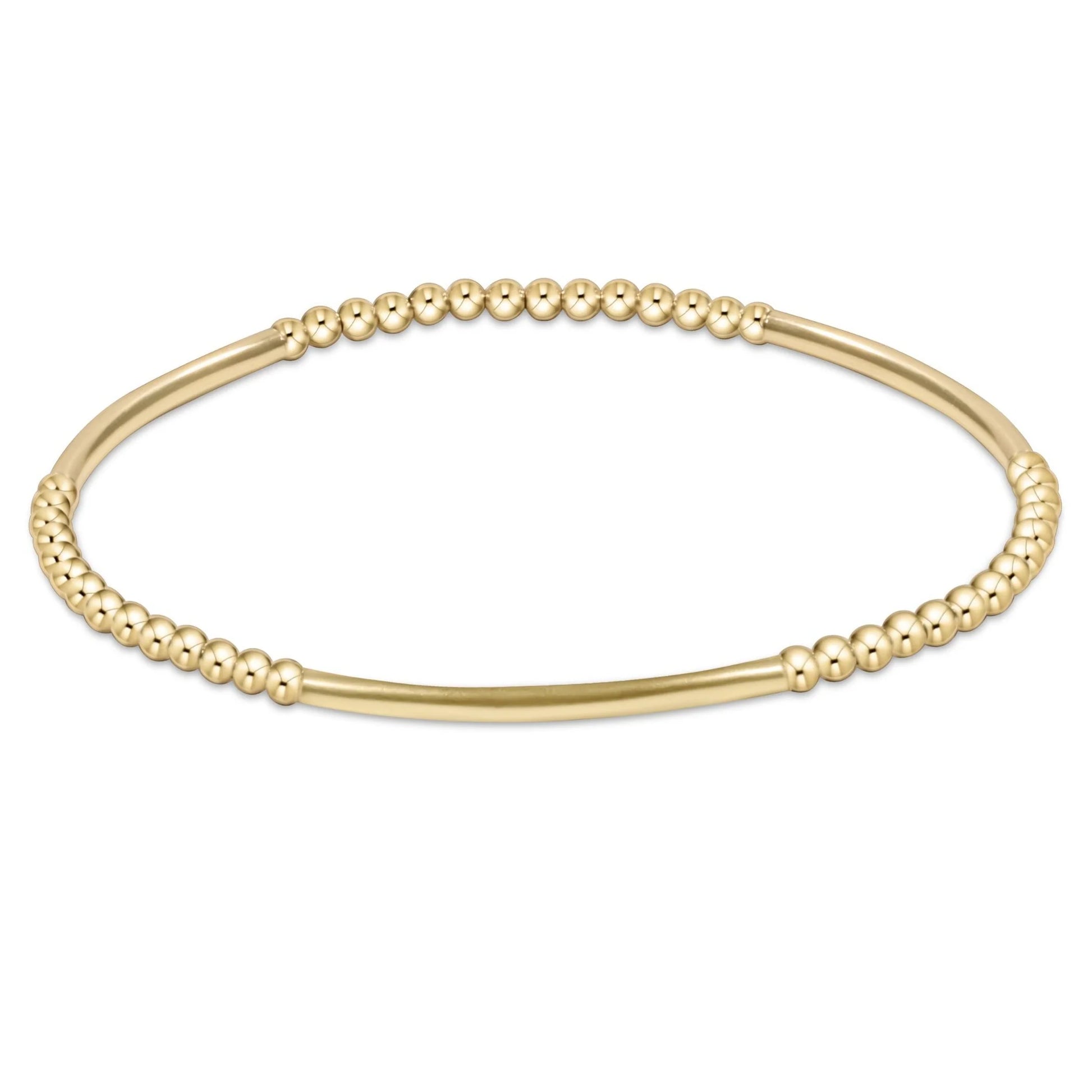 Gold beaded bracelet on a white background