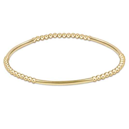 Gold beaded bracelet on a white background