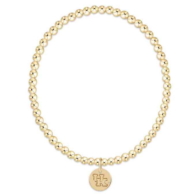 Gold beaded bracelet with a round tag on a white background