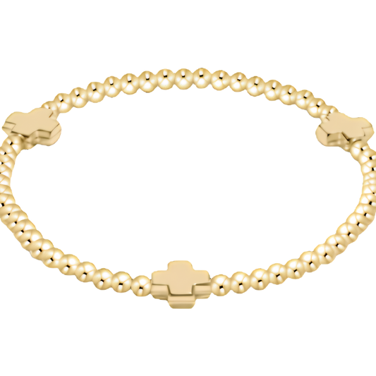 Gold bracelet with beaded crosses and on a white background