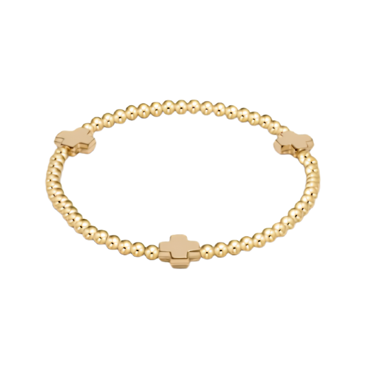 Gold bracelet with cross bead design on a white background