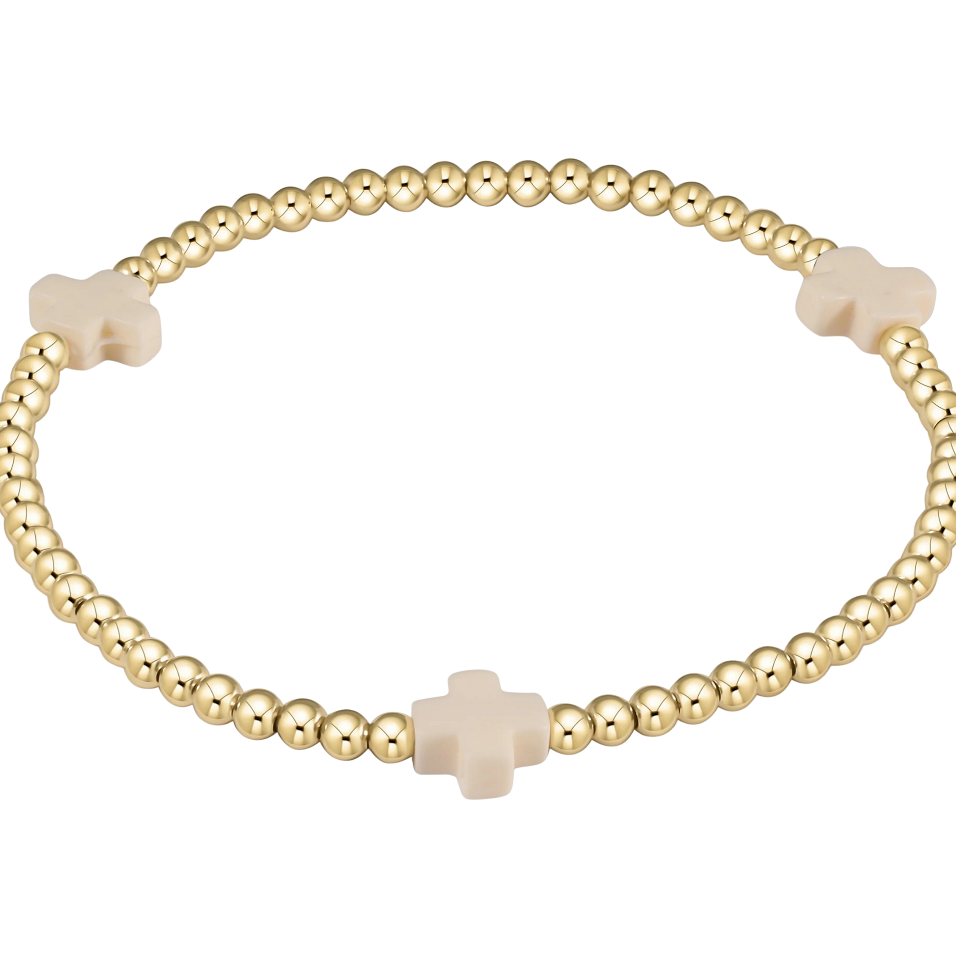 Gold beaded bracelet with beige cross beads on a white background
