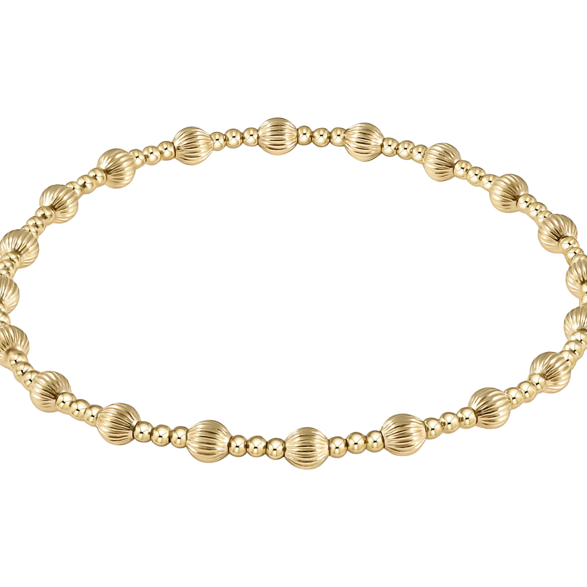 Gold beaded bracelet with textured accents on a white background