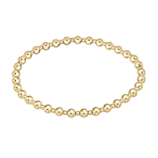 Gold beaded bracelet on a white background