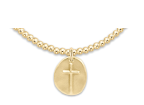 Gold necklace with a round pendant featuring a cross on a white background