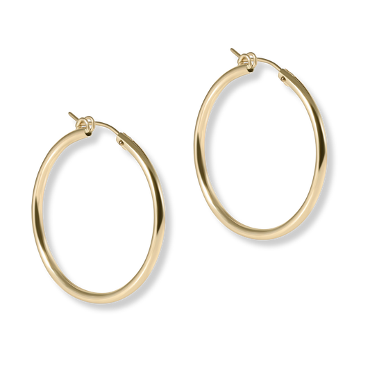 Gold hoop earrings on a white background