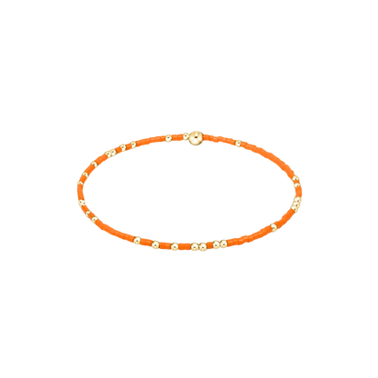 Orange beaded braclet on a white background