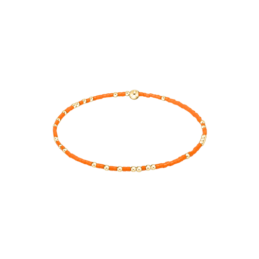 Orange beaded braclet on a white background