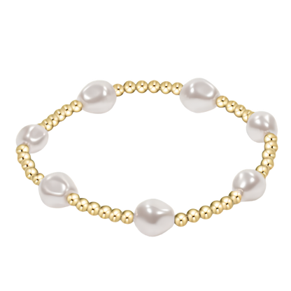 Pearl and gold beaded bracelet on a white background