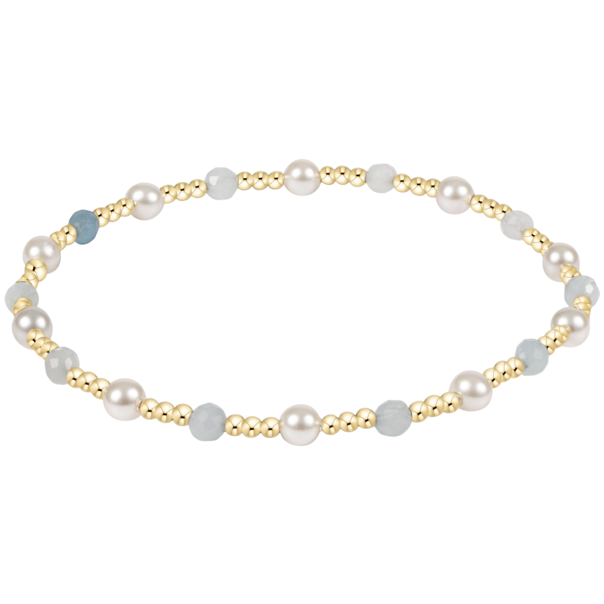 Pearl and gold beaded bracelet on a white background