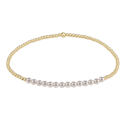 Gold necklace with white pearls on a white background