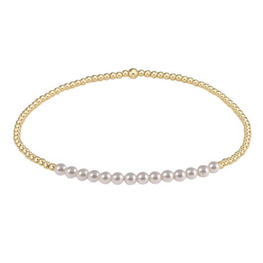 Gold necklace with white pearls on a white background