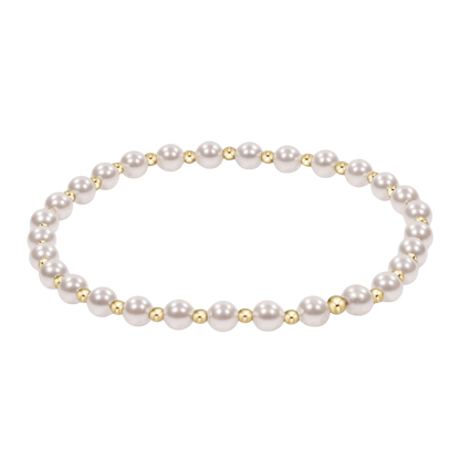 Pearl bracelet with gold accents on a white background