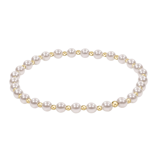 Pearl bracelet with gold accents on a white background