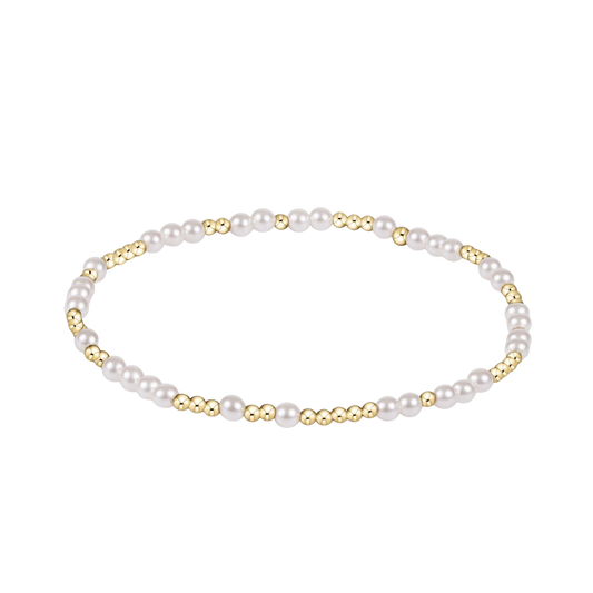 Pearl bracelet with gold accents on a white background