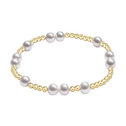 Pearl bracelet with gold accents on a white background