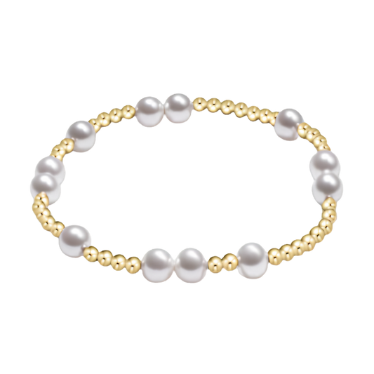 Pearl bracelet with gold accents on a white background