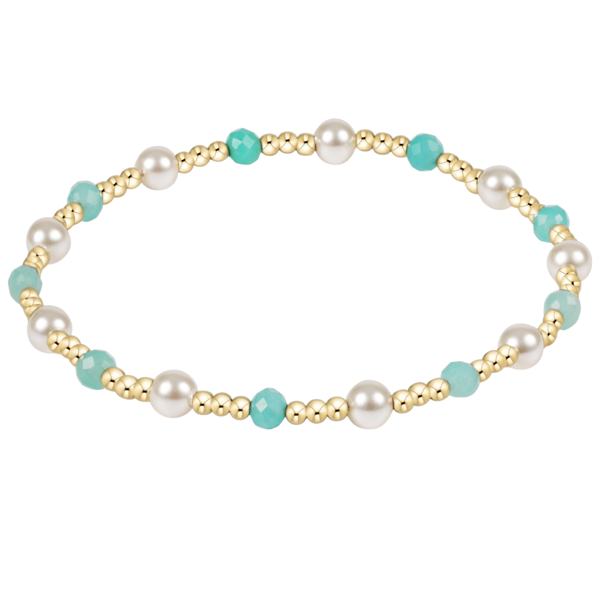 Gold bracelet with pearls and turquoise beads on a white background