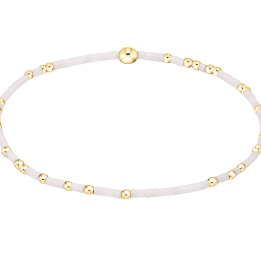 White bracelet with gold accents