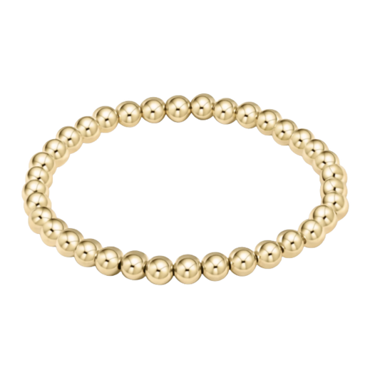 Gold beaded bracelet on a white background